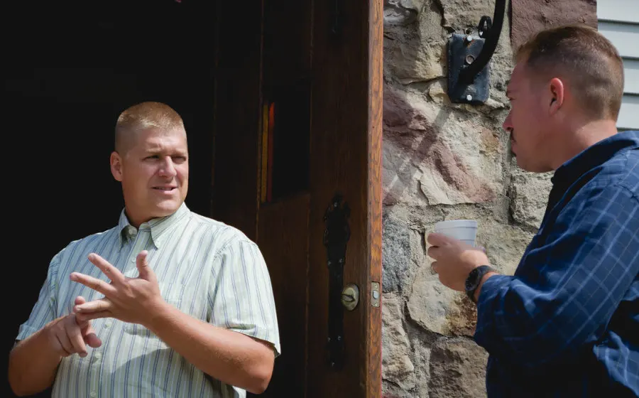 Two men talking at the church door